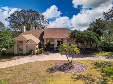 Stunning single-Gathering home with meticulous landscaping and a circular driveway, showcasing its curb appeal at 5746 Crestview Dr, Lady Lake, FL 32159