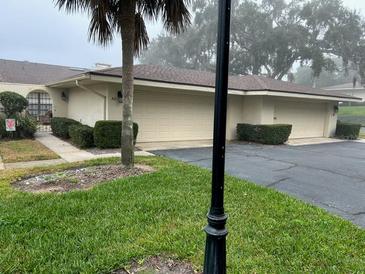 Inviting single-story home featuring a two-car garage and a well-manicured lawn at 100 S Tremain St # A2, Mount Dora, FL 32757