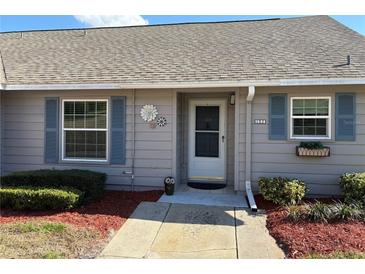 Charming single-story home featuring a cozy front entrance with manicured landscaping and inviting decor at 1152 Villa Ln # 104, Apopka, FL 32712