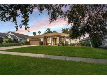 Charming single story home featuring a well maintained lawn, mature landscaping, and a two-car garage at 16627 Rockwell Heights Ln, Clermont, FL 34711