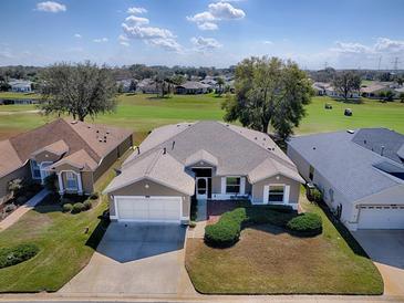 Stunning single-story home with a well-manicured lawn overlooking a beautiful golf course view at 320 Bentwood Dr, Leesburg, FL 34748