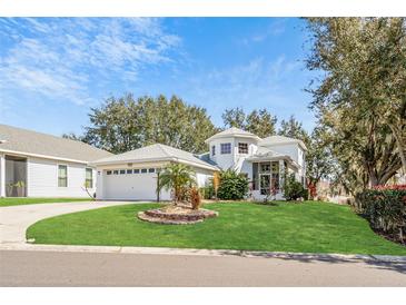 Charming two-story home with well-manicured lawn and two car garage at 6250 Sailboat Ave, Tavares, FL 32778