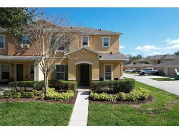 Charming two-story townhome with a well-manicured front yard and inviting entrance at 339 Winter Nellis Cir, Winter Garden, FL 34787