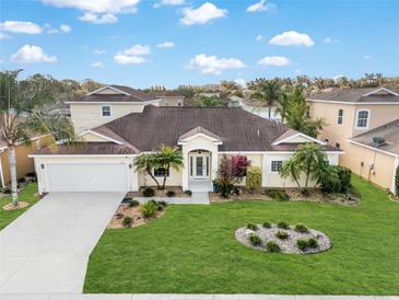 Beautiful single-story home featuring a well-manicured lawn and mature trees at 4955 Ne 124Th Rd, Oxford, FL 34484