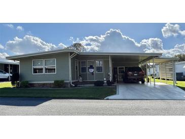 Charming single-story home with carport and well-maintained landscaping at 127 Hibiscus Way, Leesburg, FL 34748