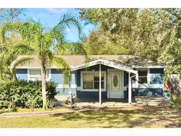 Charming single-story home with a well-manicured lawn and a beautiful palm tree in the front yard at 15747 Old Highway 50, Clermont, FL 34711