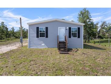 Charming single-Gathering home showcasing a well-maintained lawn, simple landscaping, and a welcoming entrance at 17442 Eve Dr, Montverde, FL 34756