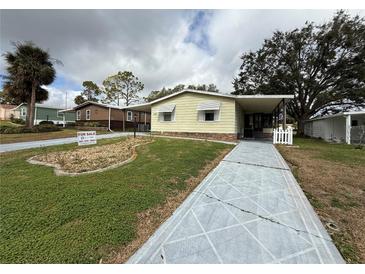 Inviting single-story home featuring a well-maintained lawn and charming curb appeal at 1532 W Schwartz Blvd, Lady Lake, FL 32159