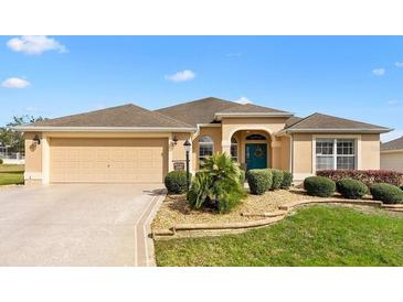 Charming single-story home featuring a well-maintained front yard and attached two-car garage at 2197 Derringer Ave, The Villages, FL 32162