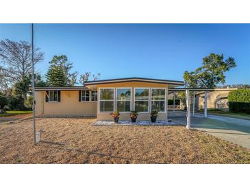 Charming single-story home with a well-maintained gravel front yard and covered parking, offering curb appeal at 2714 Vindale Rd, Tavares, FL 32778