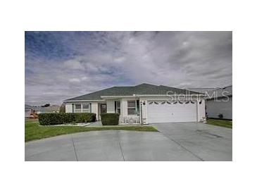 Charming single-story home with a two-car garage and well-maintained landscaping at 3067 Southern Trce, The Villages, FL 32162