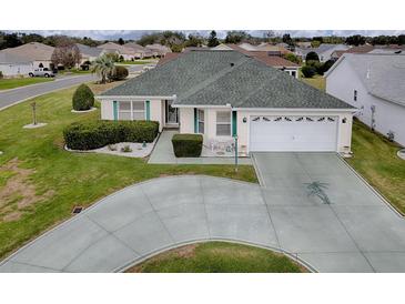Well maintained single-story home featuring a circular driveway and manicured landscaping at 3067 Southern Trce, The Villages, FL 32162