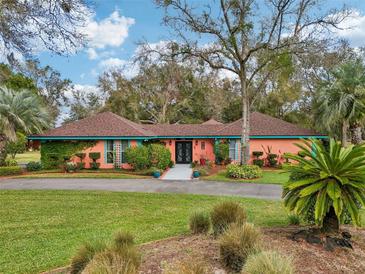 Beautiful front yard featuring a well-maintained lawn and a charming home with a colorful exterior at 36816 Taylor Mill Rd, Fruitland Park, FL 34731