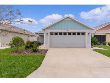 Charming home featuring a two-car garage, well-maintained landscaping and inviting curb appeal at 5934 Kaplan Ct, The Villages, FL 32163
