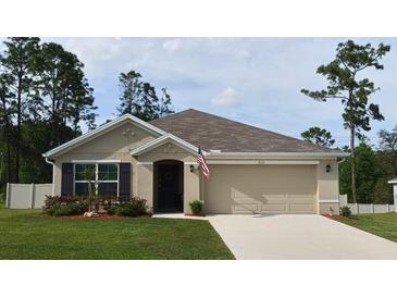 Charming one-story home with a well-manicured lawn and a neutral-colored exterior at 7133 Sw 135Th Pl, Ocala, FL 34473