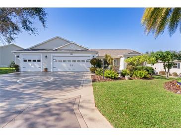 Charming home features a three-car garage and meticulously maintained landscaping, enhancing its curb appeal at 1508 Lakewood Dr, The Villages, FL 32162