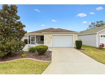 Charming single-story home with a well-manicured lawn and a two-car garage at 2245 Hanover Ter, The Villages, FL 32162