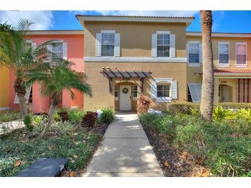 Charming townhome featuring a well-kept walkway and a welcoming entrance at 2754 Sun Key Pl, Kissimmee, FL 34747