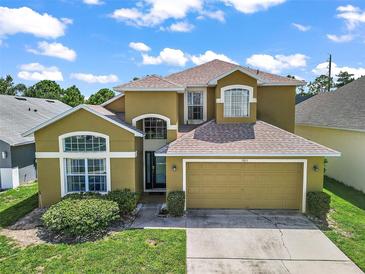 Charming two-story home with a spacious two-car garage, well-maintained lawn, and inviting curb appeal at 2903 Blooming Alamanda Loop, Kissimmee, FL 34747