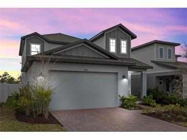 Charming two-story home featuring a brick driveway and well-manicured landscaping at 2289 Mystic Maze Ln, Minneola, FL 34715