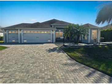 Charming single-story home featuring a three-car garage and a beautifully paved driveway at 2082 Vision Ct, The Villages, FL 32163