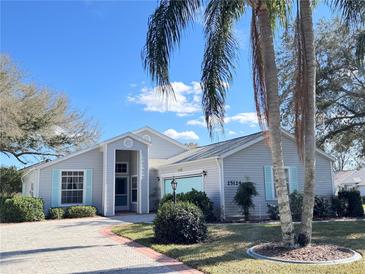 Charming single-story home featuring a well-manicured lawn and a brick-paved driveway at 25124 Twelve Oaks Rd, Leesburg, FL 34748