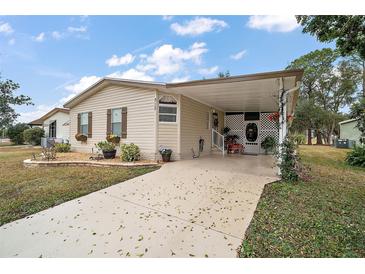 Charming single Gathering home featuring covered parking and well-maintained landscaping at 313 Westwood Dr, Leesburg, FL 34748