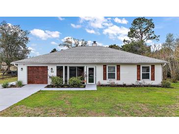 Charming single-story home features a well-manicured lawn, inviting entrance, and attached garage at 50 Pecan Run Crse, Ocala, FL 34472