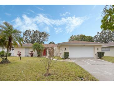 Charming single-story home with a well-manicured lawn and an attached two-car garage at 516 Spring Oaks Blvd, Altamonte Springs, FL 32714