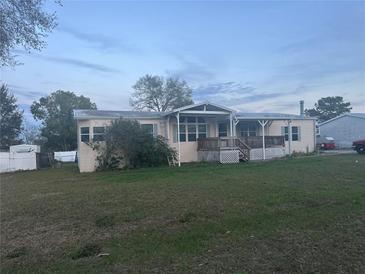 Charming single-story home featuring a welcoming porch and spacious front yard at 11428 Pheasant Trl, Leesburg, FL 34788