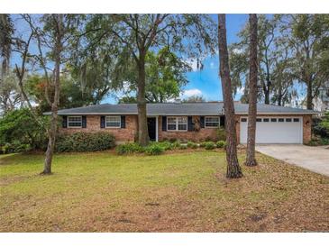 Charming one-story brick home features a well-maintained yard with mature trees and a two-car garage at 1840 12Th St, Clermont, FL 34711