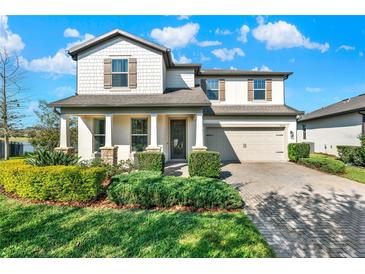 Charming two-story home featuring a well-manicured lawn and a welcoming front porch at 2505 Civitas Pl, Casselberry, FL 32707