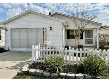 Charming single-story home with white picket fence and well-maintained landscaping at 2910 Barboza Dr, The Villages, FL 32162