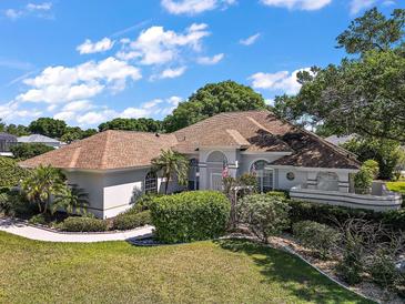 Charming single story home with well-manicured landscaping and a welcoming facade at 39100 Tacoma Dr, Lady Lake, FL 32159