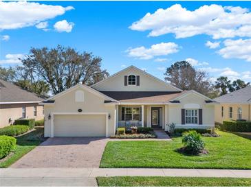 Charming one-story home with well-manicured lawn, brick driveway, and attached two-car garage at 995 Hidden Blf, Clermont, FL 34711