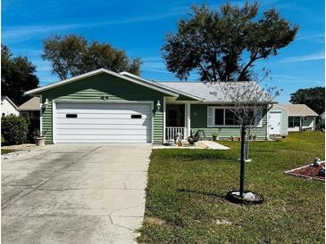 Charming single-story home with a well-maintained lawn and attached garage at 1108 Ben Hope Dr, Leesburg, FL 34788