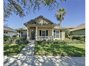 Charming single-story home with a well-manicured lawn and inviting front porch and sidewalk at 12919 Freeman St, Windermere, FL 34786