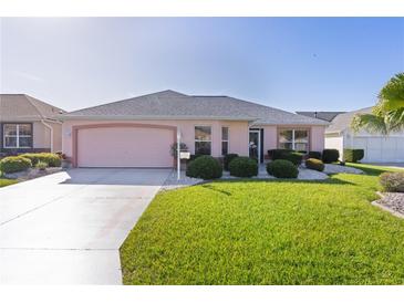 Charming single-story home featuring a well-manicured lawn and a two-car garage at 3056 Saint Thomas Ln, The Villages, FL 32162