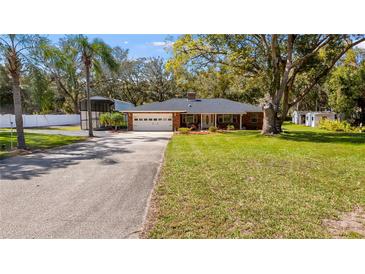 Charming single story brick home with an attached garage and a large front yard at 11136 Bronson Rd, Clermont, FL 34711