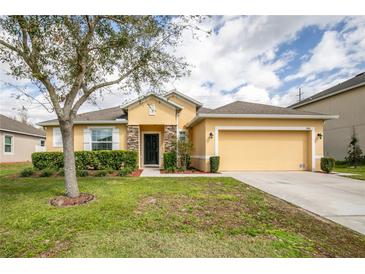 Charming single-Gathering home with a two-car garage and well-maintained landscaping at 1841 Dunn Cove Dr, Apopka, FL 32703