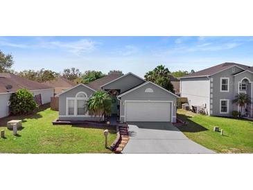 Charming single-story home with a well-manicured lawn and attached two-car garage at 1917 Emily Blvd, Winter Haven, FL 33884