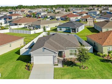 Charming single-Gathering home with attached garage, well-manicured lawn and neighborhood view at 3935 Fescue St, Clermont, FL 34714