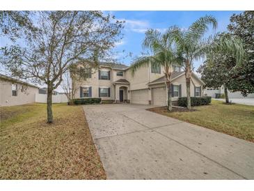 Inviting two-story home featuring a well-manicured lawn and a spacious three-car garage at 4654 Coppola Dr, Mount Dora, FL 32757