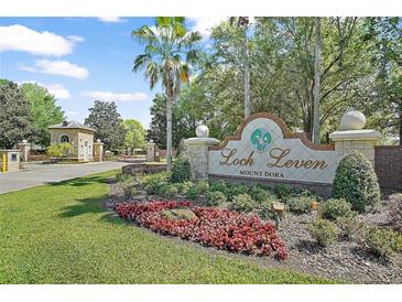 Loch Leven Mount Dora community entrance sign with landscaped flowers and plants on a sunny day at 2031 Capri Ln, Mount Dora, FL 32757