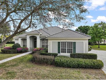 Charming single-story home with a well-manicured lawn and colorful flower beds at 2031 Capri Ln, Mount Dora, FL 32757