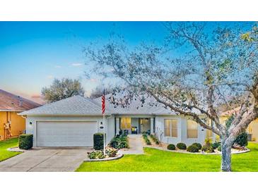 Charming single-story home with a well-manicured lawn and an inviting front entrance at 26821 Augusta Springs Cir, Leesburg, FL 34748