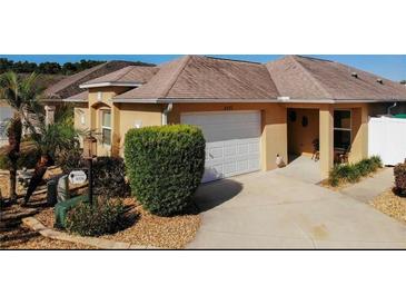 Charming single-story home featuring a well-maintained lawn, driveway, and attached garage at 3076 Gulfport Ct, The Villages, FL 32163