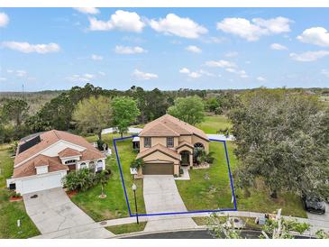 Expansive aerial shot of a single-Gathering home with a well-manicured lawn and a long driveway at 3320 Callerton Rd, Clermont, FL 34714