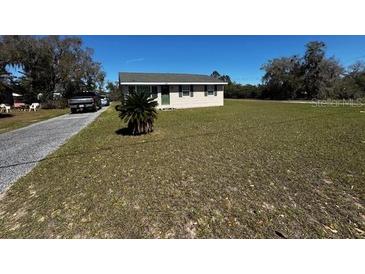 Charming single-story home with a spacious front yard and a quaint, welcoming facade at 11701 Layton St, Leesburg, FL 34788