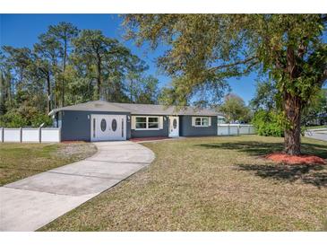 Charming home featuring a well-manicured lawn, long driveway, and inviting exterior at 16 General Doolittle Rd, Daytona Beach, FL 32124